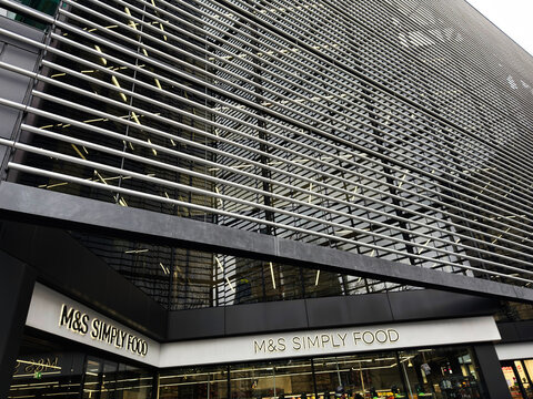 M and S Simply Food storefront with modern louvred facade and reflective glass in London, UK showcasing contemporary urban retail design