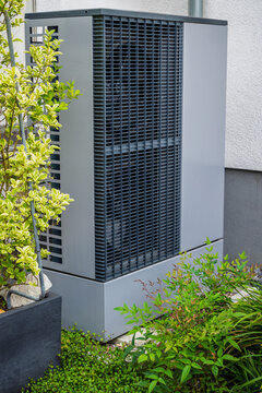 Modern heat pump unit installed outdoors for efficient home climate control