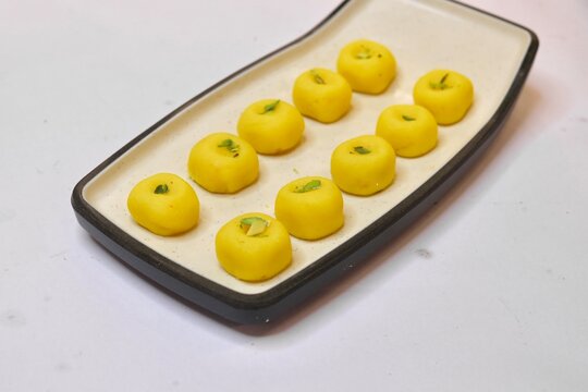 Peda sweet garnished with pista on white plate