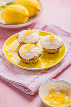 Delicate poppy seed lemon cupcakes topped with fluffy white frosting and zest