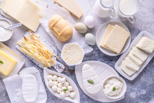 Assortment of dairy products including various cheeses, milk, and butter