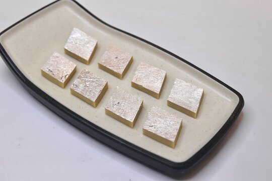 Kaju katli sweet made with cashew on a white plate