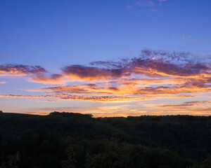 Fototapeta premium Glowing Sunset Clouds Above Peaceful Countryside