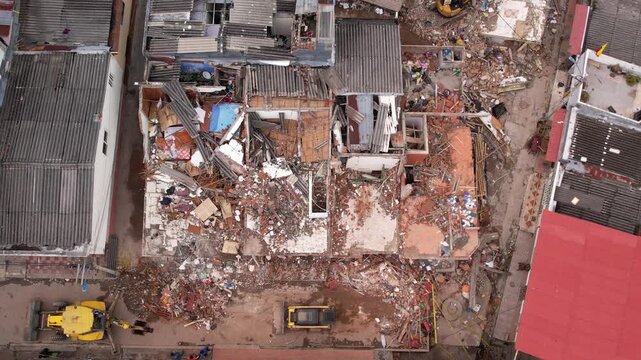 Aerial drone view of severely damaged houses, rubble, and collapsed roofs in the Grisales neighborhood, Quimbaya, Quindio, Colombia, following the August 2026 earthquake