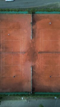 Aerial Top-Down View of Clay Tennis Courts with Players During Match