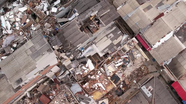 Aerial drone view of severely damaged houses, rubble, and collapsed roofs in the Grisales neighborhood, Quimbaya, Quindio, Colombia, following the August 2026 earthquake