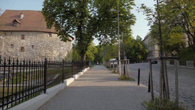 Historic Gunpowder Tower and Quiet Street in Lviv
Historic stone Gunpowder Tower beside a peaceful tree-lined pedestrian walkway in central Lviv, Ukraine.