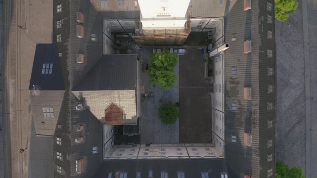 Top Down Aerial View of Historic Courtyard in Lviv
Vertical drone view of a quiet inner courtyard enclosed by historic buildings and dark rooftops in central Lviv.