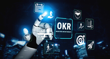 Obraz premium Digital Hand Interacting with Icons Representing Objectives and Key Results in a Futuristic Business Environment for Performance Management Fluxor.
