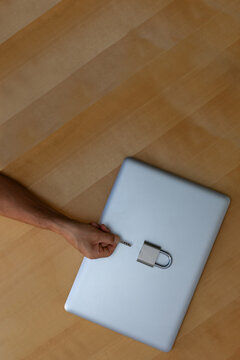 Vertical top view of secure laptop with padlock and key