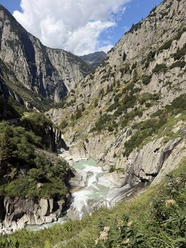 Alpine river flowing through a rocky gorge near Andermatt in the Swiss Alps