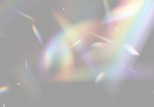 Light refraction creates multi-colored prism shapes against a dark background. The vibrant spectrum includes soft glows and sharp angular light fragments. This effect highlights optical.