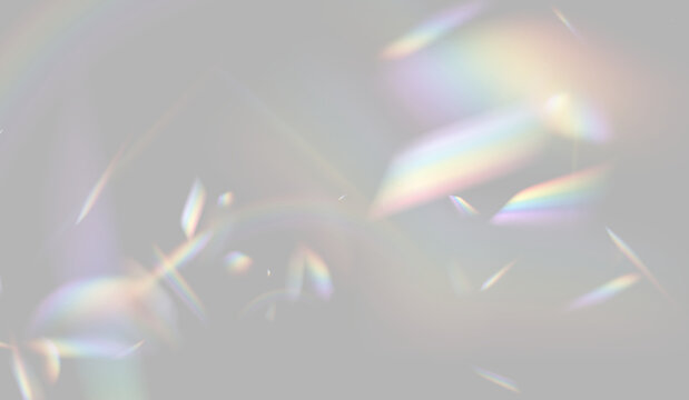 Prismatic light refracted into sharp, colorful geometric fragments. These shapes display a spectrum of hues on a deep, dark background. This effect highlights optical dispersion for visual.