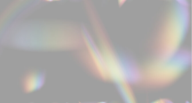 Colorful light refractions create a soft spectrum on a dark background. The overlapping bands display smooth gradients of red, orange, yellow, green, blue, and purple hues.