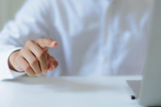 Businessman index finger pointing forward pressing virtual touchscreen interface