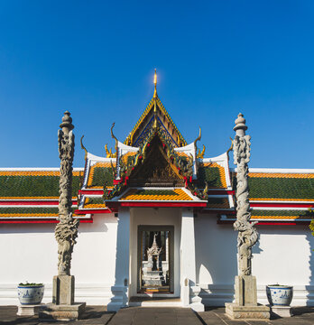 Symmetrical Entrance Gate Flanked by Carved Stone Dragon Pillars at Wat Arun Temple in Bangkok Thailand