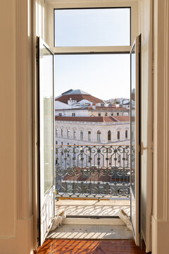 doorway in empty Portugal apartment leading out to balcony with sweeping city views