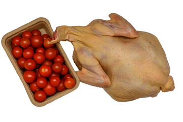 Studio shot of a whole raw chicken and a box of cherry tomatoes on a white background © Михаил Шорохов