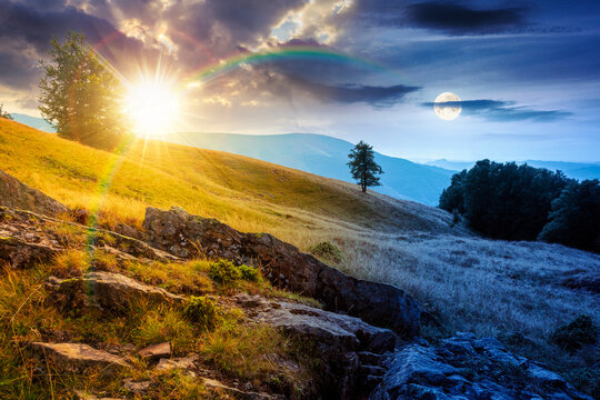 day meet night above mountain field. sun and moon over on autumn equinox. countryside view with beech forest on the grassy hill. clouds on epic sky. wonderful astrology background