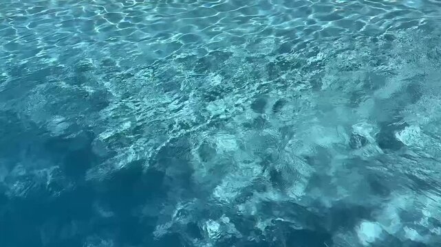 Clear Blue Swimming Pool Water Surface With Natural Ripples Texture