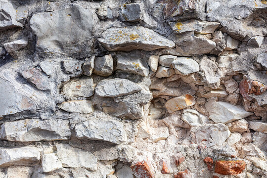 Rugged gray stone wall texture with rock blocks