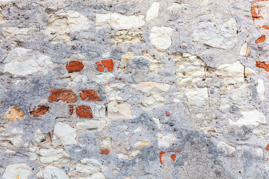 Old wall texture with exposed brick and crumbling plaster