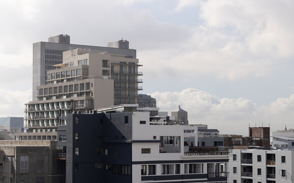 Mid-rise buildings are forming stepped terraces and balconies with glass windows and rooftop HVAC