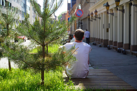 Man sitting on urban parklet in Oslo, Norway