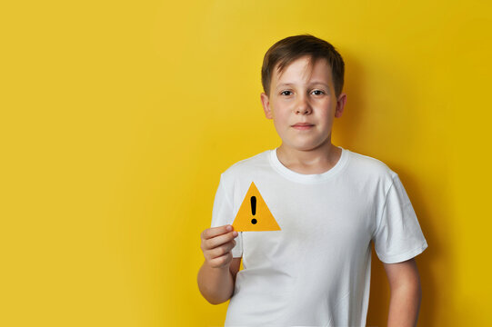 Boy Holding Warning Symbol