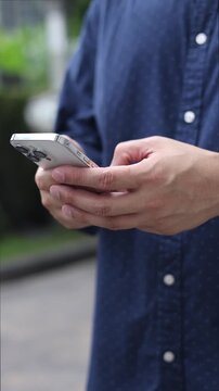slow motion young man hand hold smartphone to surfing the internet and check work or mail on website while sit in the living room in weekend for business technology and lifestyle concept