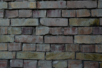 Obraz premium Weathered brick wall with rough aged texture