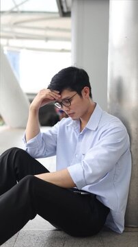 slow motion scene adult employee man sit on ground outside office with stress emotion after disappoint from job interview or  unemployed for economic global  and busness concept