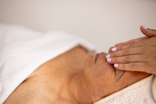 Professional forehead massage during facial skincare treatment