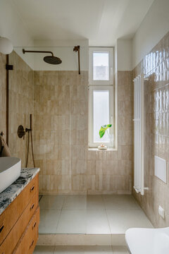 Modern bathroom with shower head and tiled walls for daily routine