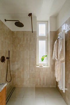 Bathroom with shower head and natural light in an apartment during morning routine