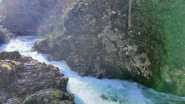 Stunning turquoise water of the Radovna River rapidly flowing through the narrow Vintgar Gorge, a natural wonder in Triglav National Park