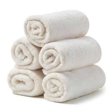 A stack of soft, white rolled towels, perfect for a relaxing spa or bathroom setting.