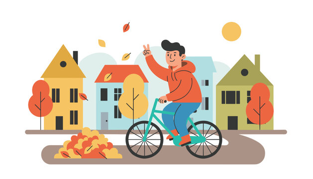 Happy teenage boy in a hoodie rides his bicycle down a cozy neighborhood street during the scenic autumn season.