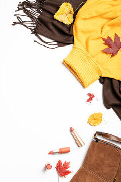 Autumn cloth and accessories at white background with copy space.