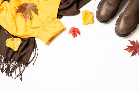 Autumn cloth and accessories at white background with copy space.