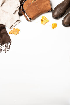 Autumn cloth and accessories at white background with copy space.