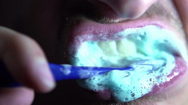 Close up of mouth brushing teeth slow motion
