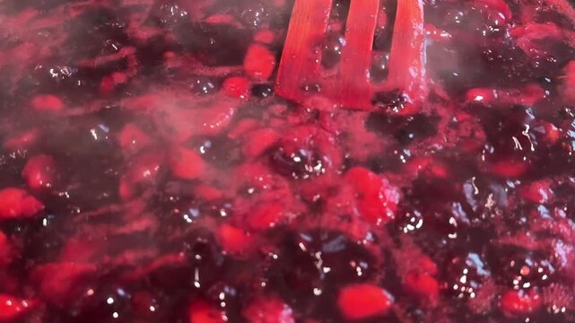 Blueberry jam is cooking in the frying pan
