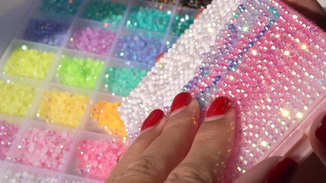 Bedazzled object sparkling in the sunlight, covered with colorful gems and rhinestones that shimmer and reflect the light. Close-up of dazzling details, vibrant colors, glamour, creativity