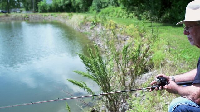 Man patiently fishing at pond
