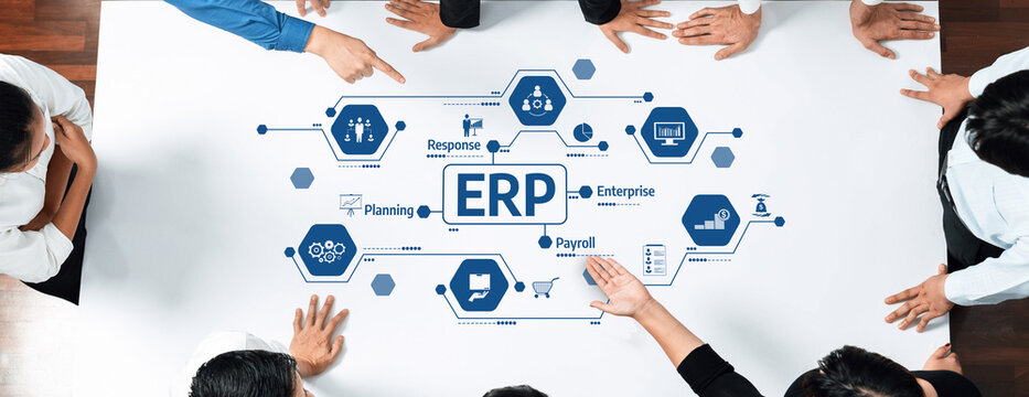 A diverse group of professionals collaborates around a table, discussing the implementation of an ERP system while analyzing essential business processes and strategies. Amity
