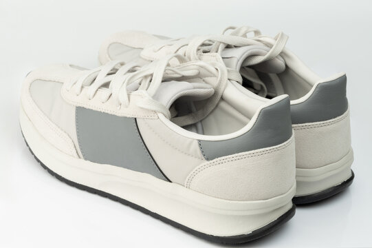 New sneakers in light colors with gray accents on a white surface