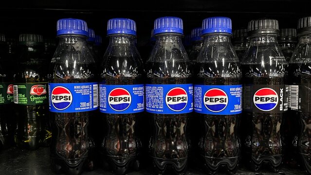 Salvador, Brazil - August 24, 2026: Small PET bottles of Pepsi soft drink on a supermarket shelf in Brazil. Pepsi small 200ml plastic bottle drink.