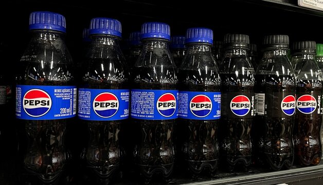 Salvador, Brazil - August 24, 2026: Small PET bottles of Pepsi soft drink on a supermarket shelf in Brazil. Pepsi small 200ml plastic bottle drink.