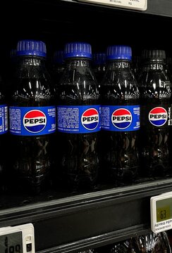 Salvador, Brazil - August 24, 2026: Small PET bottles of Pepsi soft drink on a supermarket shelf in Brazil. Pepsi small 200ml plastic bottle drink.